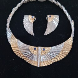 An Art Deco necklace and earrings by the artist Erte'. Gold and sapphires.